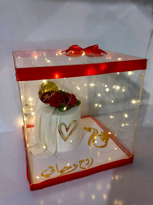 bat pakki cake in acrylic box with kights nad ribbo decore